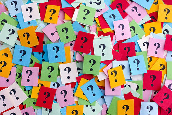 board of sticky notes with question marks