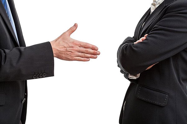 business person reaching out for handshake related post image