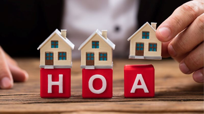 red letters spelling out HOA with little houses on top