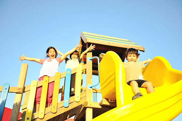 kids playing on playground in hoa community