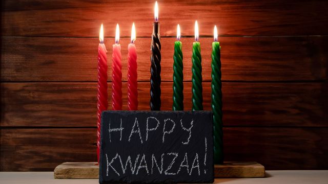 happy kwanzaa sign with candles