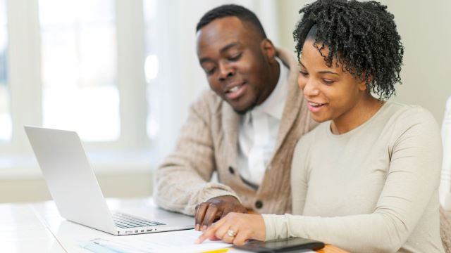 Couple calculating finances for buying a condo