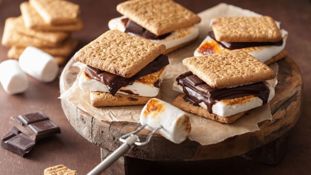 plate of s'mores next to roasted marshmallow