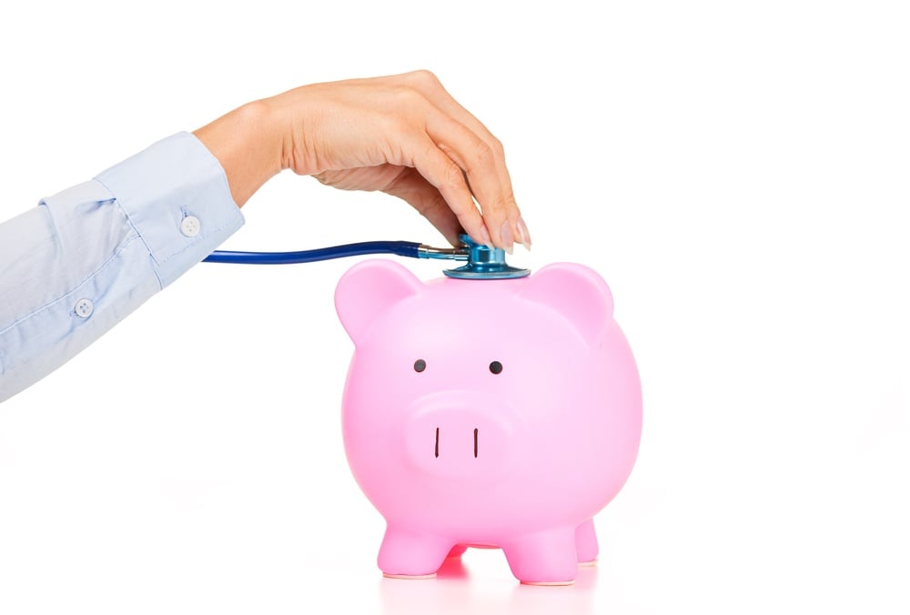 Woman hand stethoscope pink piggy bank Isolated on white background. Health care cost. Financial state condition self assessment concept. Financial system checkup, savings for medical insurance costs.jpeg